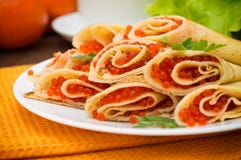 Rolls pancakes with red caviar. Russian cuisine. Flat lay. Maslenitsa. Wooden background. Close-up stock photo Rolls pancakes with red caviar. Russian cuisine. Flat lay. Maslenitsa. Wooden background. Close-up stock photo