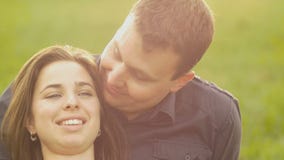 Romance of a young couple in love park sunset slow motion stock footage Romance of a young couple in love park sunset slow motion stock footage