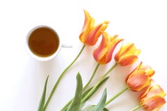 Romantic background with cup of tea and tulips on white table. Soft photo. Greeting card style, place for text. Top view royalty free stock photos Romantic background with cup of tea and tulips on white table. Soft photo. Greeting card style, place for text. Top view royalty free stock photos