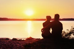 Romantic couple on the beach at colorful sunset background royalty free stock image Romantic couple on the beach at colorful sunset background royalty free stock image