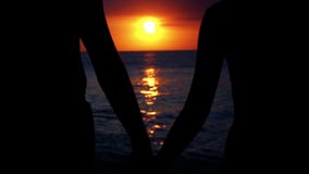 romantic couple at beach during sunset