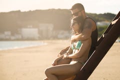Romantic couple in hug watching sunrise/ sunset together.Young man and woman in love Stock Images Romantic couple in hug watching sunrise/ sunset together.Young man and woman in love Stock Images