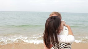 Romantic Couple Hugging And Kissing On Beach Together