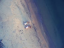 Romantic Couple Is Lying On The Beach Stock Images