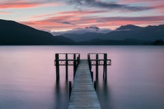 Romantic wharf on Te Anau on South Island of New Zealand Beautiful pier on sunrise. Lake Te Anau is the largest lake. royalty free stock images Romantic wharf on Te Anau on South Island of New Zealand Beautiful pier on sunrise. Lake Te Anau is the largest lake. royalty free stock images