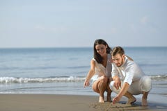 Romantic young couple draw heart shapes in the sand while on honeymoon. summer beach love concept. Royalty Free Stock Photos Romantic young couple draw heart shapes in the sand while on honeymoon. summer beach love concept. Royalty Free Stock Photos
