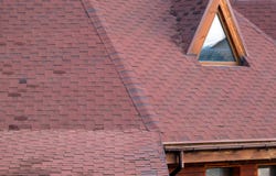 Roof Asphalt Shingles and Attic Mansard Window. Roofing Construction. Roofing Repair. Rain gutter stock photo Roof Asphalt Shingles and Attic Mansard Window. Roofing Construction. Roofing Repair. Rain gutter stock photo