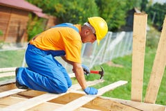 Roofer carpenter works on roof Stock Image Roofer carpenter works on roof Stock Image