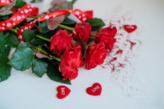 Rose flowers, red ribbon and decorative hearts on light wooden background royalty free stock photography Rose flowers, red ribbon and decorative hearts on light wooden background royalty free stock photography