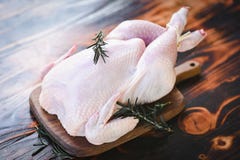 Rosemary Chicken Meat - Fresh Raw Chicken Whole On Wooden Board On White Wood Background Royalty Free Stock Image
