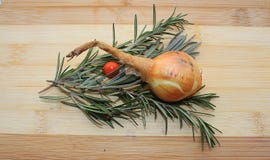 Rosemary,onion, red berry and lavender on a wooden board stock photography Rosemary,onion, red berry and lavender on a wooden board stock photography