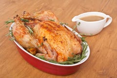 Rosemary Turkey arrostita in un piatto con sugo immagine stock Rosemary Turkey arrostita in un piatto con sugo immagine stock