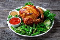 Rotisserie chicken with fried pods of peas