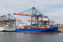 Container terminal in Dutch harbor Rotterdam with cargo ships moored royalty free stock images Container terminal in Dutch harbor Rotterdam with cargo ships moored royalty free stock images