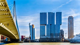 Modern High Rise buildings with the Cable-Stayed Erasmus Bridge over the Nieuwe Maas River in Rotterdam royalty free stock image Modern High Rise buildings with the Cable-Stayed Erasmus Bridge over the Nieuwe Maas River in Rotterdam royalty free stock image