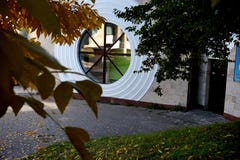Round large window and a tree branch with yellow leaves. royalty free stock photo Round large window and a tree branch with yellow leaves. royalty free stock photo