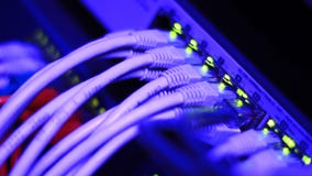 Routing data. Working Ethernet server in the data center room. Detailed clip with blinking lights and UTP cables Routing data. Working Ethernet server in the data center room. Detailed clip with blinking lights and UTP cables