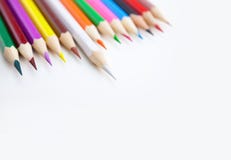 A row of colored pencils on white background with selected focus stock photo A row of colored pencils on white background with selected focus stock photo