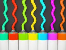 Row Of Tubes With Multicolored Paint On Grey Background Royalty Free Stock Images