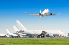 Row of passenger aircraft, airplane parked on service before departure. at the airport, other plane push back tow. One take off fr Stock Photos Row of passenger aircraft, airplane parked on service before departure. at the airport, other plane push back tow. One take off fr Stock Photos