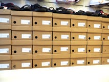 Row of shoes box and shoes stacked in store stock photos Row of shoes box and shoes stacked in store stock photos