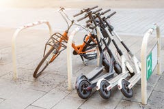 Rowerowe i elektryczne hulajnogi parkować na miasto ulicie Samoobsługowa ulica transportu wynajem usługa Czynszowy miastowy pojaz fotografia stock Rowerowe i elektryczne hulajnogi parkować na miasto ulicie Samoobsługowa ulica transportu wynajem usługa Czynszowy miastowy pojaz fotografia stock