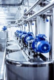 Rows of blue electric motors on tanks for mixing liquids. stock image Rows of blue electric motors on tanks for mixing liquids. stock image