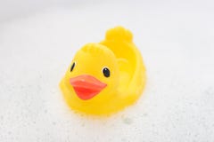 Rubber Duck In Foam Water Stock Images
