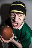Rugby player with ball in hands making wry face stock photography Rugby player with ball in hands making wry face stock photography
