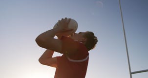 Rugby player kissing the rugby ball