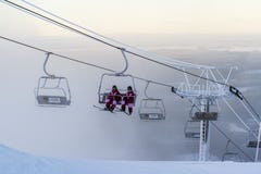 Ruka, Finland - November 27, 2012: Skiers are sitting on the chair ski lift at Ruka ski resort in freezing day stock photo Ruka, Finland - November 27, 2012: Skiers are sitting on the chair ski lift at Ruka ski resort in freezing day stock photo