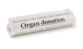 Rullande tidning med rubrikorgandonationen royaltyfria foton Rullande tidning med rubrikorgandonationen royaltyfria foton