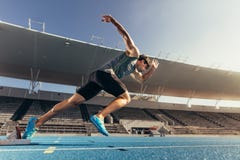 Sprinter taking off from starting block on running track Stock Images Sprinter taking off from starting block on running track Stock Images