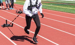 Runners pulling weighted sleds on a track royalty free stock images Runners pulling weighted sleds on a track royalty free stock images
