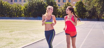Runners on the stadium track. Women summer fitness workout royalty free stock photos Runners on the stadium track. Women summer fitness workout royalty free stock photos