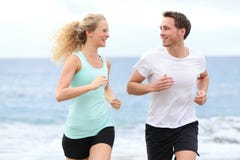 Running couple jogging exercising on beach talking Stock Photo Running couple jogging exercising on beach talking Stock Photo