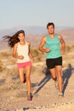 Running couple - runners jogging on trail run path stock photography Running couple - runners jogging on trail run path stock photography