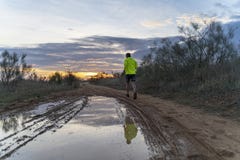 Running in the field at sunset in shorts, with sneakers. stock photos Running in the field at sunset in shorts, with sneakers. stock photos