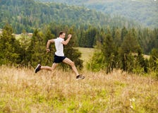 Running Fitness Man Sprinting Outdoors With Beautiful Mountains Landscape On Background. Caucasian Sport Male Runner Training For Stock Image