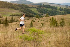 Running Fitness Man Sprinting Outdoors With Beautiful Mountains Landscape On Background. Caucasian Sport Male Runner Training For Royalty Free Stock Photo