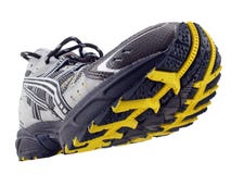 Running Shoe yellow black tread pattern tilted up stock photography Running Shoe yellow black tread pattern tilted up stock photography