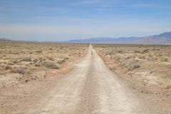 A rural dirt road stretches toward the horizon.