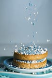 rusk with falling blue aniseed balls, muisjes, tradition in the Netherlands to celebrate the birth of a son stock photo rusk with falling blue aniseed balls, muisjes, tradition in the Netherlands to celebrate the birth of a son stock photo