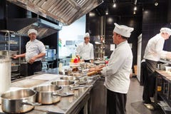 Russia, Moscow, 01.02.2019, Four Chefs In The Form, In The Kitchen, Preparing Food Using Cutlery Royalty Free Stock Image Russia, Moscow, 01.02.2019, Four Chefs In The Form, In The Kitchen, Preparing Food Using Cutlery Royalty Free Stock Image