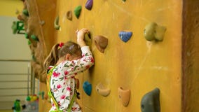 Russia, Moscow - Feb 22, 2021 Sports climbing kids turnstile leisure, girl recreational pursuit risk, active. hobby well