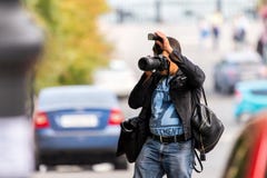 Russia, Rostov on Don, September 09, 2018: Professional photographer shoots photo with Nikon DSLR camera with flashlight and lens stock images Russia, Rostov on Don, September 09, 2018: Professional photographer shoots photo with Nikon DSLR camera with flashlight and lens stock images