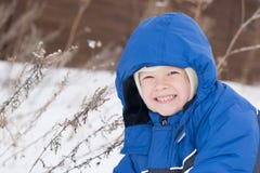 Happy boy lying in a snow stock photos Happy boy lying in a snow stock photos