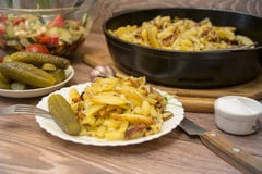 Russian national cuisine: fried potatoes with pickled cucumber, garlic. stock photos Russian national cuisine: fried potatoes with pickled cucumber, garlic. stock photos