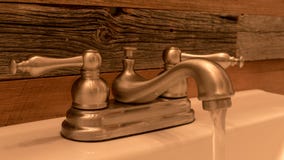 Rustic Bathroom Faucet With Weathered Wood Wall Background Morning