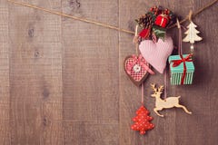 Rustic Christmas decorations hanging over wooden background with copy space